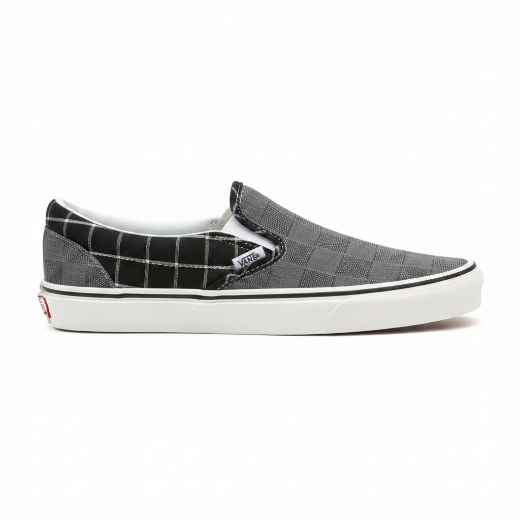 Grey Vans Classic Slip-On sneakers from Raw-Movement featuring a sleek low-top design and comfortable canvas material.