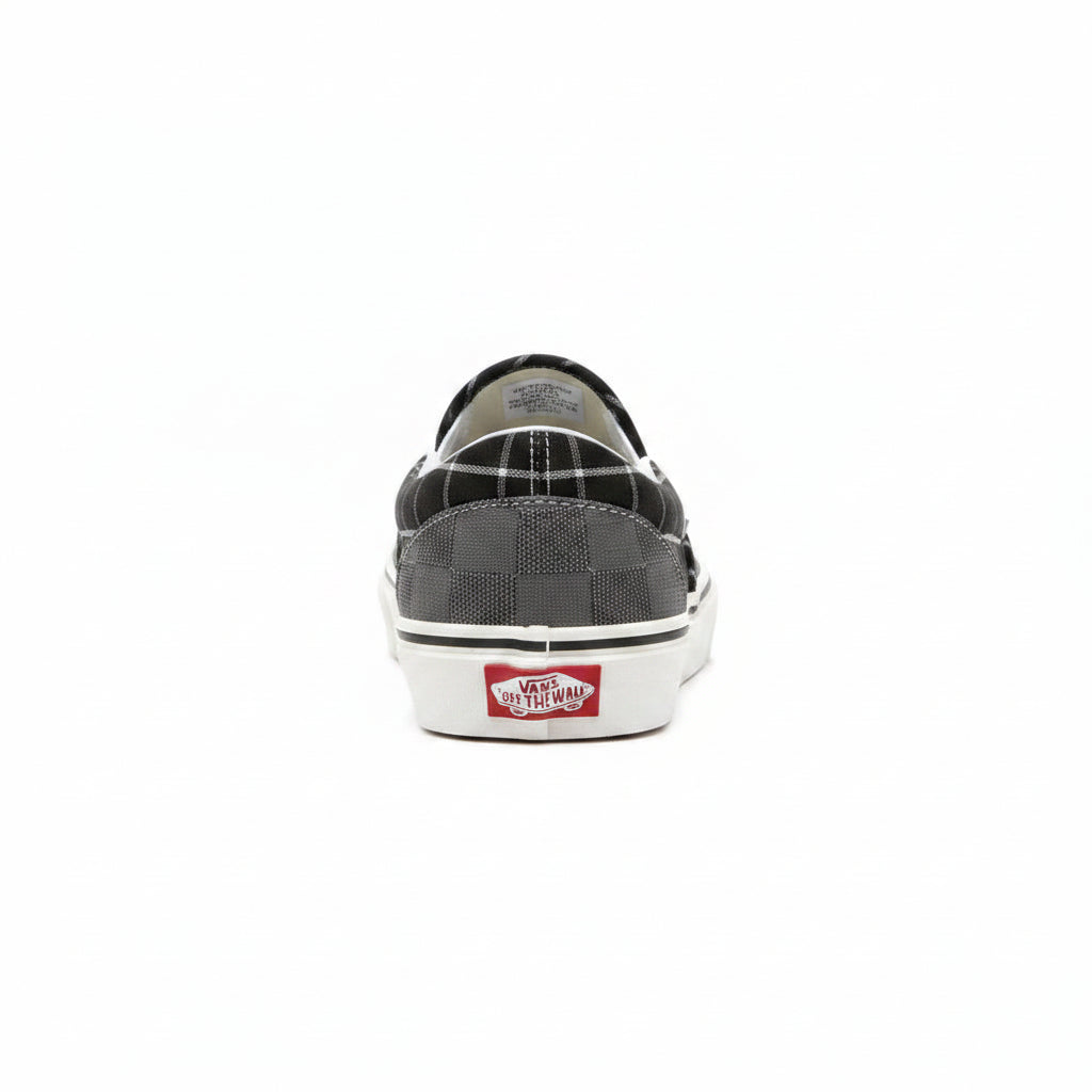 Grey Vans Classic Slip-On sneakers by Raw Movement with canvas upper and rubber sole, positioned on a flat surface.
