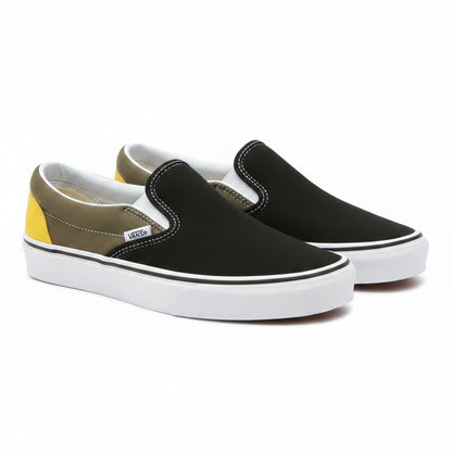 Black Vans Classic Slip-On sneakers by Raw-Movement, showing the low-profile canvas shoes with elastic side panels and white sole.